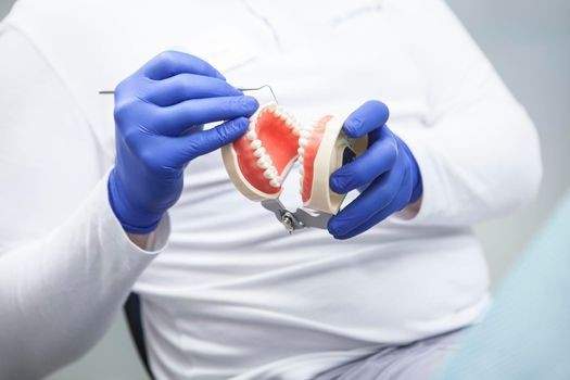 Man working on a set of false teeth