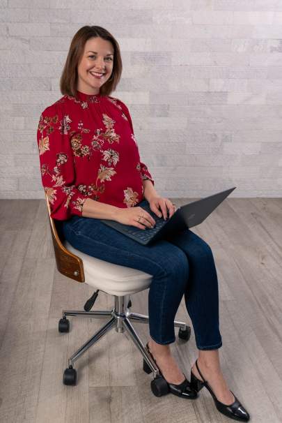 Andrea Kraft sitting in a chair with a laptop in her lap